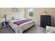 Well-lit bedroom with carpet, a large window, and a view of the outdoors at 6758 Hillis Dr, Lakeland, FL 33813