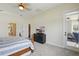 Bedroom featuring neutral walls, a ceiling fan, and access to a private patio at 6758 Hillis Dr, Lakeland, FL 33813