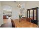 This dining area features an archway to the kitchen, hardwood floors and a stylish hanging light fixture at 6758 Hillis Dr, Lakeland, FL 33813