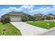 Beautiful single-story home with a well manicured lawn and a two-car garage at 6758 Hillis Dr, Lakeland, FL 33813