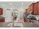 Modern kitchen with stainless appliances, stone counters, and a direct view of the adjacent dining area at 6758 Hillis Dr, Lakeland, FL 33813