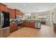 The kitchen features stainless steel appliances, wood cabinets, granite counters, a breakfast nook and tile floors at 6758 Hillis Dr, Lakeland, FL 33813