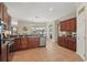 This kitchen features stainless appliances, wood cabinets, granite counters, tile floors and a pantry at 6758 Hillis Dr, Lakeland, FL 33813