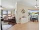 View of the combined living room and breakfast nook featuring neutral tones and a sunny window overlooking backyard at 6758 Hillis Dr, Lakeland, FL 33813