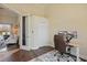 Bright home office with wood floors, closet, and dual monitor setup on adjustable height desk at 6758 Hillis Dr, Lakeland, FL 33813