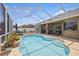 Gorgeous pool area with a screened enclosure, ample seating, and meticulous landscaping for outdoor enjoyment at 6758 Hillis Dr, Lakeland, FL 33813