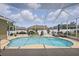 Private screened-in pool boasts a waterfall feature, ample lounge space, and lush landscaping for an oasis feel at 6758 Hillis Dr, Lakeland, FL 33813