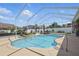 Enjoy this private screened-in pool featuring a tranquil waterfall, lounge chairs, and lush landscaping at 6758 Hillis Dr, Lakeland, FL 33813