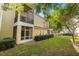 Exterior view of home with manicured lawn and screened-in patio at 676 Sandy Neck Ln # 102, Altamonte Springs, FL 32714