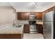 Stylish kitchen with granite countertops and stainless steel appliances at 676 Sandy Neck Ln # 102, Altamonte Springs, FL 32714