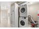 Hallway laundry room features stacked washer and dryer at 676 Sandy Neck Ln # 102, Altamonte Springs, FL 32714