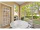Screened-in patio area features a round table and chairs at 676 Sandy Neck Ln # 102, Altamonte Springs, FL 32714