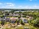 Aerial view showcasing the layout of the property with a pool and proximity to lake at 724 Wildmere Village Cv, Longwood, FL 32750