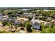Aerial view of a residential neighborhood featuring single Gathering homes with well maintained lawns and mature trees at 724 Wildmere Village Cv, Longwood, FL 32750