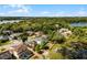 Aerial view of a serene neighborhood with houses nestled around a lake and mature trees at 724 Wildmere Village Cv, Longwood, FL 32750