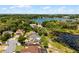 Aerial view of a serene neighborhood with houses nestled around a lake and mature trees at 724 Wildmere Village Cv, Longwood, FL 32750