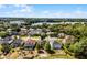 Lovely aerial view of homes near a picturesque lake with lush trees and serene blue skies at 724 Wildmere Village Cv, Longwood, FL 32750