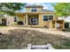 Back of home view featuring a covered patio, fire pit, chicken coop and tranquil surroundings at 724 Wildmere Village Cv, Longwood, FL 32750