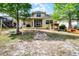 Enjoy outdoor living with a covered patio, fire pit, mature trees, chicken coop and lake at 724 Wildmere Village Cv, Longwood, FL 32750