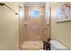 Modern bathroom features glass enclosed tiled shower and a window for natural light at 724 Wildmere Village Cv, Longwood, FL 32750