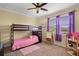 Bright bedroom features a bunk bed, a ceiling fan, and natural light from the large window at 724 Wildmere Village Cv, Longwood, FL 32750