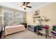 Bright bedroom with a ceiling fan, study space, and windows with lots of natural sunlight at 724 Wildmere Village Cv, Longwood, FL 32750