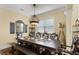 Elegant dining room with a large table, unique chairs, decorative lighting, and stylish decor at 724 Wildmere Village Cv, Longwood, FL 32750