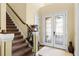 Inviting entryway with decorative glass doors, staircase, and hardwood floors at 724 Wildmere Village Cv, Longwood, FL 32750