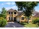 Charming two-story home with a well-maintained lawn and beautiful landscaping at 724 Wildmere Village Cv, Longwood, FL 32750