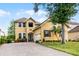 Inviting two-story home with manicured lawn and mature palm trees at 724 Wildmere Village Cv, Longwood, FL 32750