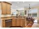 Bright kitchen with granite countertops, stainless steel appliances, breakfast nook and open concept living area at 724 Wildmere Village Cv, Longwood, FL 32750