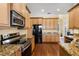Well-equipped kitchen with stainless steel appliances, granite countertops, and ample cabinet space at 724 Wildmere Village Cv, Longwood, FL 32750