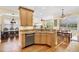 Bright eat-in kitchen with granite countertops, stainless steel appliances, and open concept living area at 724 Wildmere Village Cv, Longwood, FL 32750