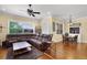 Spacious living room area featuring a leather sectional and an adjacent breakfast nook with a table and chairs at 724 Wildmere Village Cv, Longwood, FL 32750