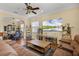 Open-concept living area with comfortable seating, a large TV, and dining space with a unique design at 724 Wildmere Village Cv, Longwood, FL 32750