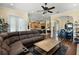 Open concept space with a living room area featuring a sectional sofa and a dining area with seating at 724 Wildmere Village Cv, Longwood, FL 32750