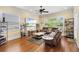 Comfortable living room with a plush leather sectional, hardwood floors, and plenty of natural light at 724 Wildmere Village Cv, Longwood, FL 32750