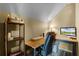 Comfortable home office with ample desk space, built-in shelving, and a cozy office chair at 724 Wildmere Village Cv, Longwood, FL 32750