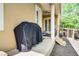 Covered patio with a grill, seating and easy access to yard and lush landscaping at 724 Wildmere Village Cv, Longwood, FL 32750