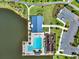 Overhead view showcasing the community pool, playground, parking, and clubhouse by a serene lake at 765 Terrapin Dr, Debary, FL 32713
