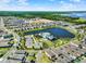High-angle view of a lakeside community featuring modern homes, lush landscapes, and recreational amenities at 765 Terrapin Dr, Debary, FL 32713