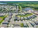 Expansive aerial view of a residential community featuring modern homes, green spaces, and a serene lake at 765 Terrapin Dr, Debary, FL 32713