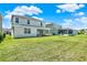 Spacious backyard with vibrant green grass and a covered patio area, ideal for relaxation at 765 Terrapin Dr, Debary, FL 32713