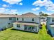 Two-story home showcasing the large backyard and covered patio in a well-maintained residential area at 765 Terrapin Dr, Debary, FL 32713