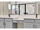 Bright bathroom featuring a double sink vanity with a white countertop and stylish black hardware at 765 Terrapin Dr, Debary, FL 32713