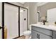 Bathroom featuring a walk-in shower with white subway tile and a sleek gray vanity at 765 Terrapin Dr, Debary, FL 32713