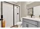 Bathroom featuring a walk-in shower with white subway tile and a sleek gray vanity at 765 Terrapin Dr, Debary, FL 32713