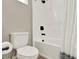 Bathroom featuring toilet, tile floors, tub shower with black fixtures and shower curtain at 765 Terrapin Dr, Debary, FL 32713