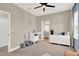 Bright bedroom features a ceiling fan, changing table and dresser for ample storage at 765 Terrapin Dr, Debary, FL 32713