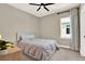 Bedroom features a ceiling fan, carpet, and a window providing natural light at 765 Terrapin Dr, Debary, FL 32713